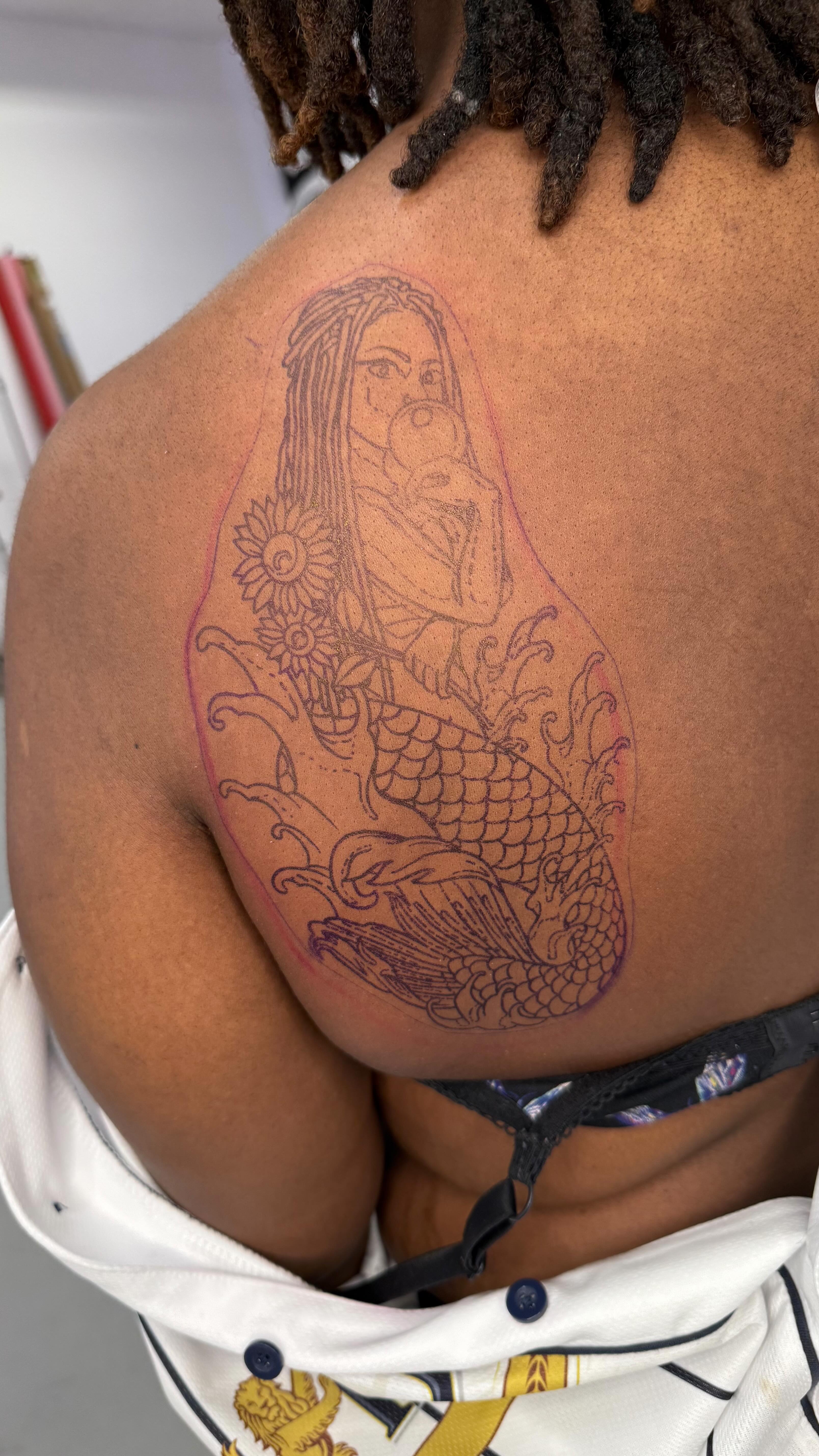 Illustrative mermaid and sunflower back tattoo linework