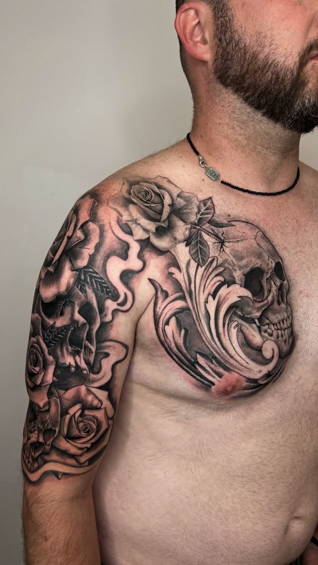 Black and grey skull and roses chest piece