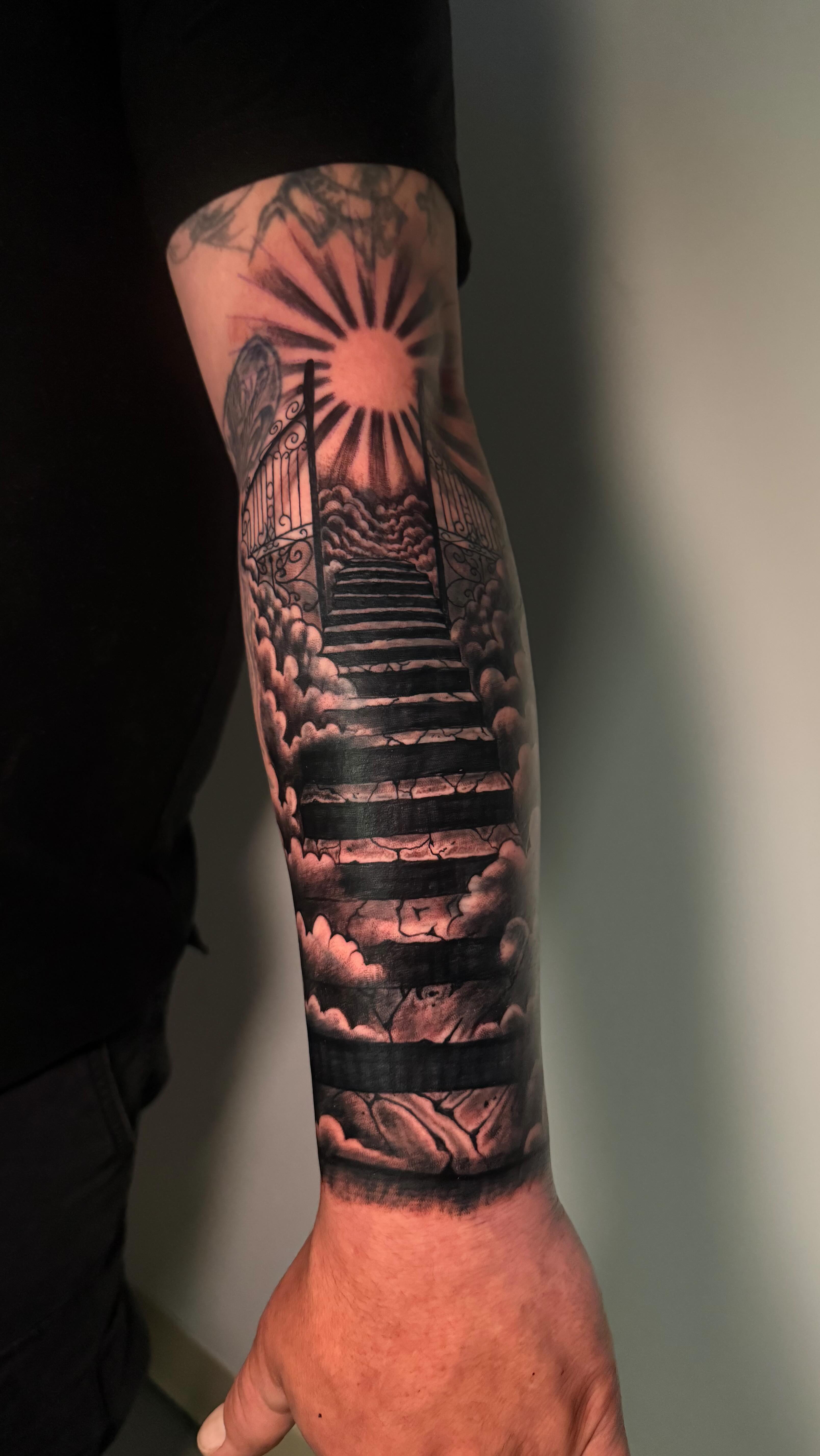 Black and grey realism stairway to heaven tattoo