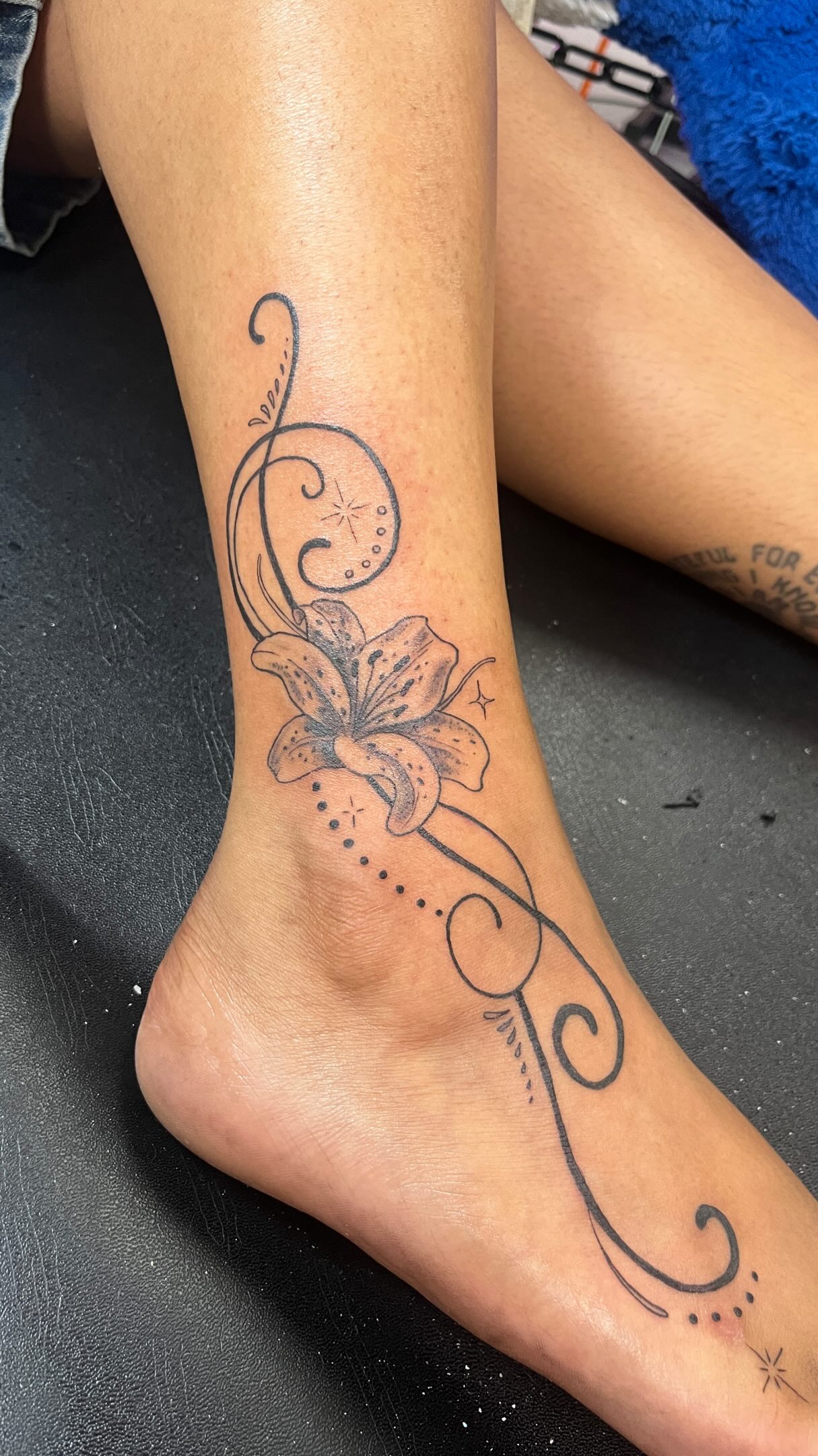 Fine line lily and filigree ankle and foot tattoo